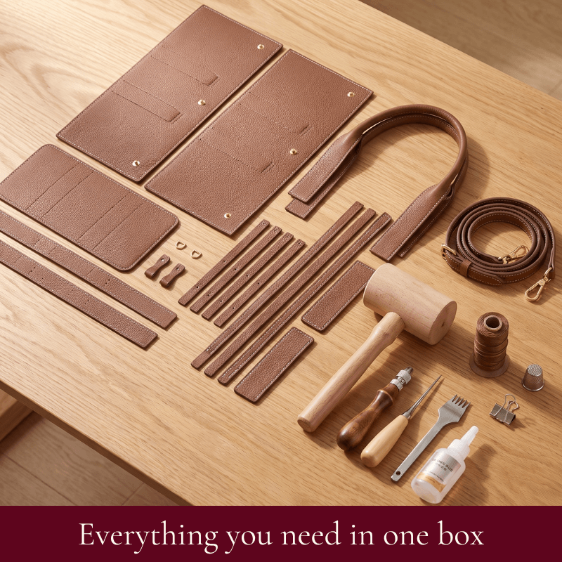 Daphne DIY tote kit contents in brown: pre-cut leather pieces, rolled handles, hardware and tools