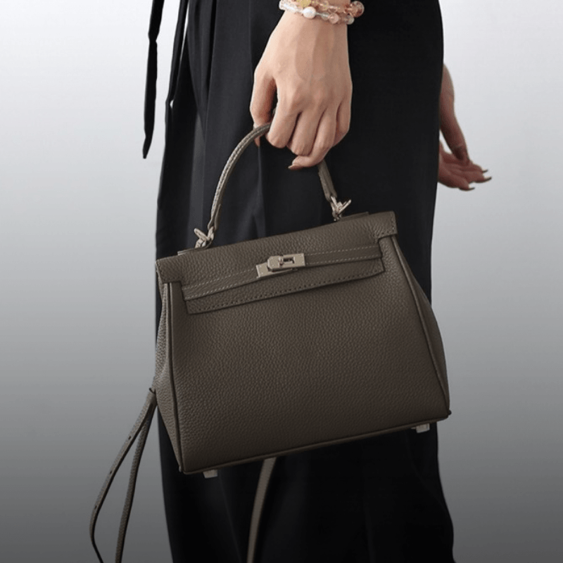 Kit Atelier DIY leather bag kits – finished Grace satchel in grey carried by its top handle
