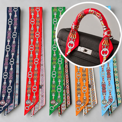 Twilly bag scarf in navy, red, green, orange and sky blue, shown tied on a bag handle